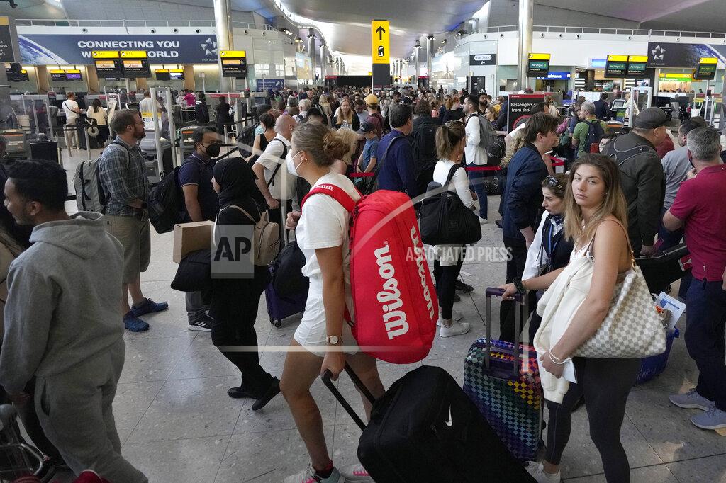 Frank Augstein Travellers queue at security at Heathrow Airport in London, Wednesday, June 22, 2022. After two years of pandemic restrictions, travel demand is back with a vengeance but airlines and airports that slashed jobs during the depths of the COVID-19 crisis are struggling to keep up. With the busy summer tourism season underway in Europe, passengers are encountering chaotic scenes at airports, including lengthy delays, canceled flights and headaches over lost luggage. (AP Photo/Frank Augstein)