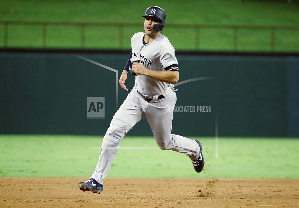 Tony Gutierrez FILE - In this Sept. 27, 2019, file photo, New York Yankees' Giancarlo Stanton sprints to third during a baseball game against the Texas Rangers in Arlington, Texas. Yankees general manager Brian Cashman is optimistic Aaron Judge, James Paxton, Aaron Hicks and Giancarlo Stanton will be ready to play in time for New York's rescheduled opener at World Series champion Washington on July 23.(AP Photo/Tony Gutierrez, File)