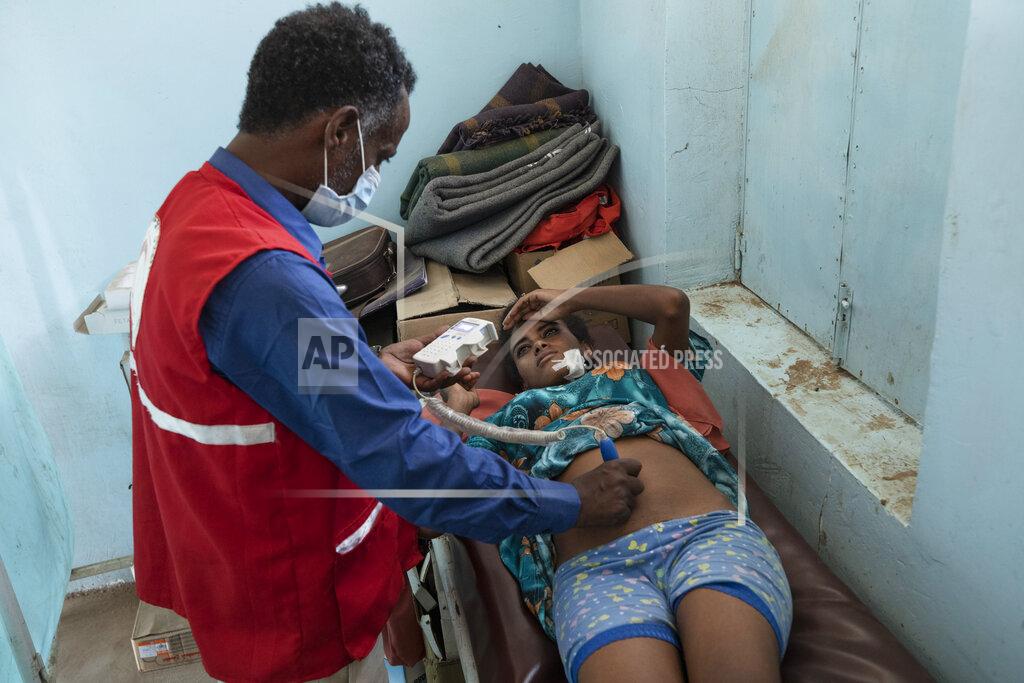 Nariman El-Mofty Surgeon and doctor-turned-refugee, Dr. Tewodros Tefera, performs an ultrasound scan on 5-month-pregnant Tigrayan refugee Rahwa Haile, inside the Sudanese Red Crescent clinic in Hamdayet, eastern Sudan, near the border with Ethiopia, on March 22, 2021. With no running water or electricity, he and a handful of colleagues see well over 100 patients a day. (AP Photo/Nariman El-Mofty)