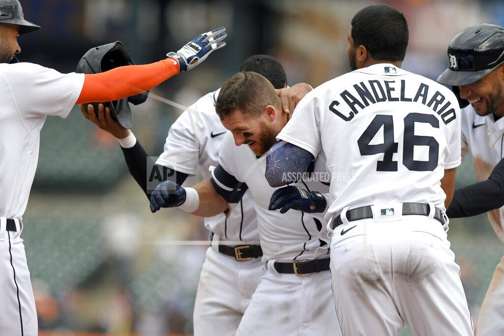 Jose Juarez Detroit Tigers' Robbie Grossman, middle, is congratualted by teammates after walking in the winning run with the bases loaded against the Tampa Bay Rays in the eleventh inning of a baseball game, Sunday, Sept. 12, 2021, in Detroit. (AP Photo/Jose Juarez)