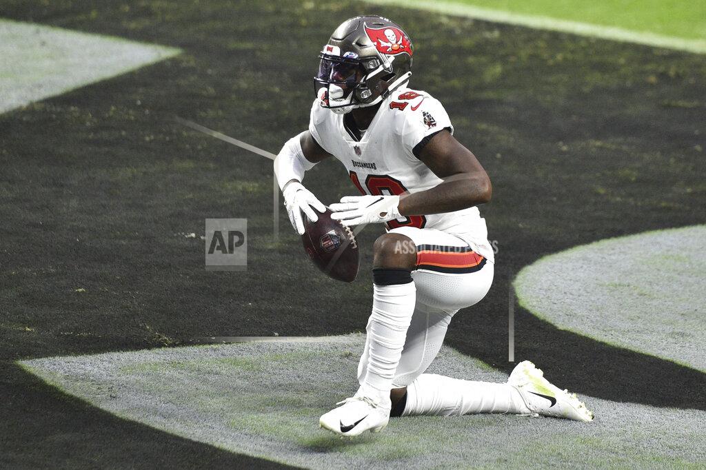 David Becker Tampa Bay Buccaneers wide receiver Tyler Johnson (18) celebrates after scoring a touchdown against the Las Vegas Raiders during the second half of an NFL football game, Sunday, Oct. 25, 2020, in Las Vegas. (AP Photo/David Becker)
