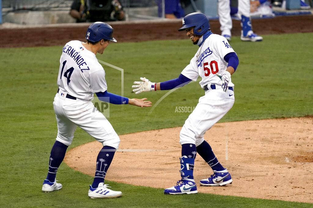 Alex Gallardo Los Angeles Dodgers' Mookie Betts, right, gets congratulations from Enrique Hernandez, after Betts hits a two-run home run against the Houston Astros during the fifth inning of a baseball game in Los Angeles, Sunday, Sept. 13, 2020. (AP Photo/Alex Gallardo)