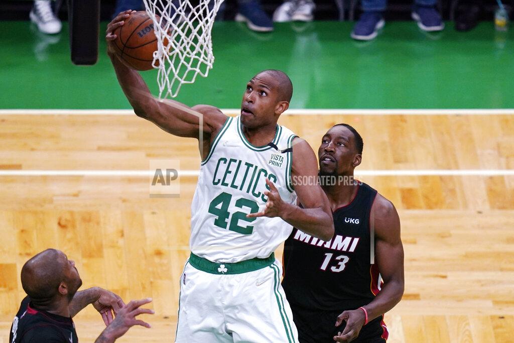 Charles Krupa Boston Celtics center Al Horford (42) grabs a rebound against Miami Heat center Bam Adebayo (13) during the first half of Game 4 of the NBA basketball playoffs Eastern Conference finals, Monday, May 23, 2022, in Boston. (AP Photo/Charles Krupa)