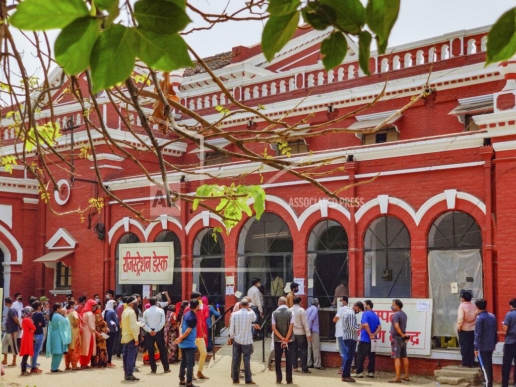 Rajesh Kumar Singh People wait in a queue to test for COVID-19 in Prayagraj, India, Thursday, April 8, 2021. India now has a seven-day rolling average of more than 80,000 cases per day and has reported 12.9 million coronavirus cases since the pandemic began, the highest after the United States and Brazil. (AP Photo/Rajesh Kumar Singh)
