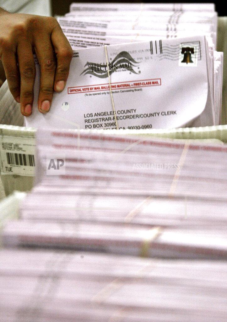Reed Saxon FILE - In this Tuesday, Oct. 28, 2008, file photo, mailed-in ballots are sorted and bundled, ready for counting at the Los Angeles County Registrar-Recorder's office in Norwalk, Calif. Over 100,000 mail-in ballots were rejected by election officials in California's March 2020 presidential primary, highlighting a glaring gap in the effort to ensure every vote is counted as a national dispute rages over the integrity of vote-by-mail elections. (AP Photo/Reed Saxon, File)