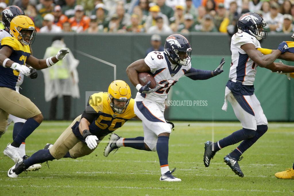 Mike Roemer Denver Broncos running back Royce Freeman (28) carries with the ball as Green Bay Packers inside linebacker Blake Martinez (50) defends during the first half of an NFL football game Sunday, Sept. 22, 2019, in Green Bay, Wis. (AP Photo/Mike Roemer)