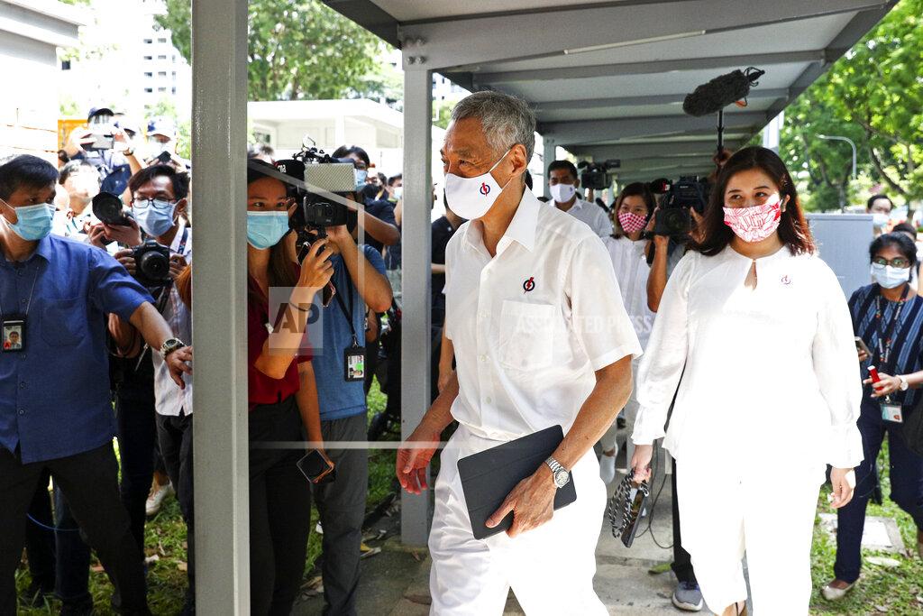 Yong Teck Lim People's Action Party Secretary-General and Singaporean Prime Minister Lee Hsien Loong, center, arrives at a nomination center with his team to submit their nomination papers ahead of the general election in Singapore, Tuesday, June 30, 2020. Campaigning began Tuesday for Singapore's general elections, with the opposition hoping to dent the ruling party's supermajority in parliament with support from Prime Minister Lee's estranged younger brother.(AP Photo/Yong Teck Lim)