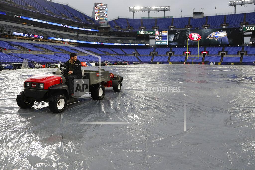 Julio Cortez Members of the ground crew use blowers to help dry off the tarp in preparation of an NFL football game between the Baltimore Ravens and the San Francisco 49ers, Sunday, Dec. 1, 2019, in Baltimore, Md. (AP Photo/Julio Cortez)