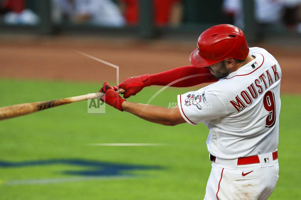 Aaron Doster Cincinnati Reds' Mike Moustakas (9) hits a two-run home run in the seventh inning during a baseball game against the Detroit Tigers at Great American Ballpark in Cincinnati, Friday, July 24, 2020. The Reds won 7-1. (AP Photo/Aaron Doster)