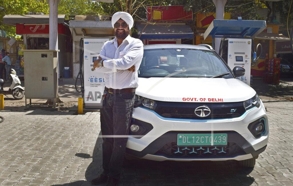 Neha Mehrotra An attendant of a public charging station for electric vehicles sits idle in New Delhi, India, Thursday, April 1, 2021. India has ambitions to expand use of electric vehicles to wean itself from polluting fossil fuels, but EVs are still a rarity on its congested highways. A lack of charging stations and poor quality batteries are discouraging drivers from switching over. (AP Photo/Neha Mehrotra)