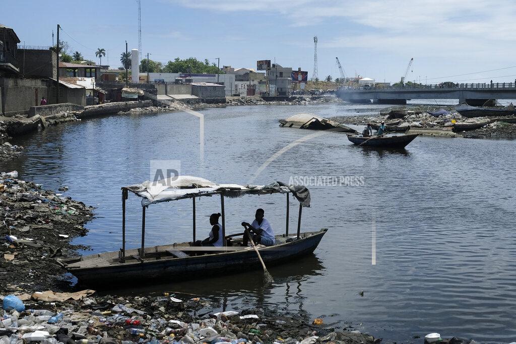 Matias Delacroix A man waits to row his boat across the river in Cap-Haitien, Haiti, Thursday, July 22, 2021. The city of Cap-Haitien is holding events to honor slain President Jovenel Moïse on Thursday ahead of Friday’s funeral. (AP Photo/Matias Delacroix)