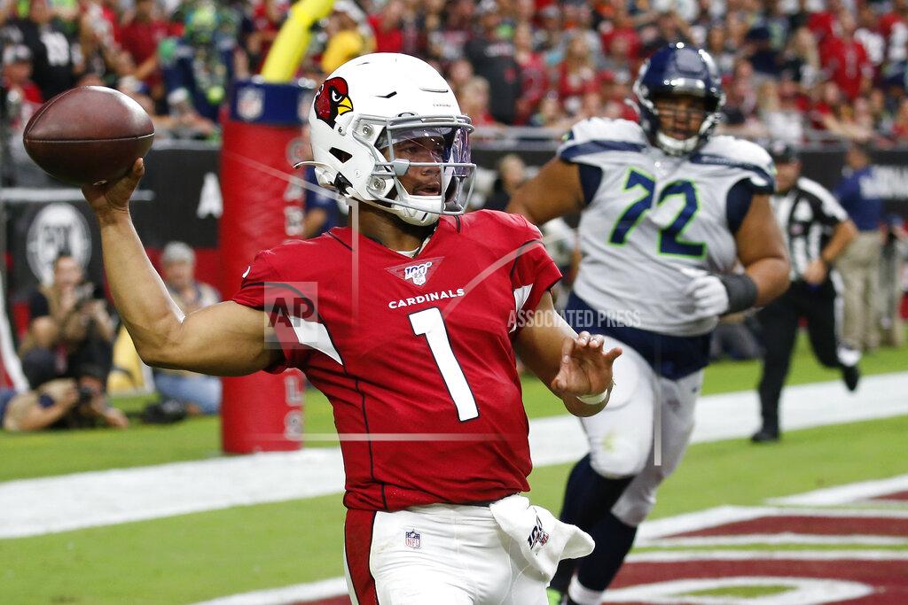 Ross D. Franklin Arizona Cardinals quarterback Kyler Murray (1) throws as Seattle Seahawks defensive tackle Al Woods (72) pursues during the first half of an NFL football game, Sunday, Sept. 29, 2019, in Glendale, Ariz. (AP Photo/Ross D. Franklin)