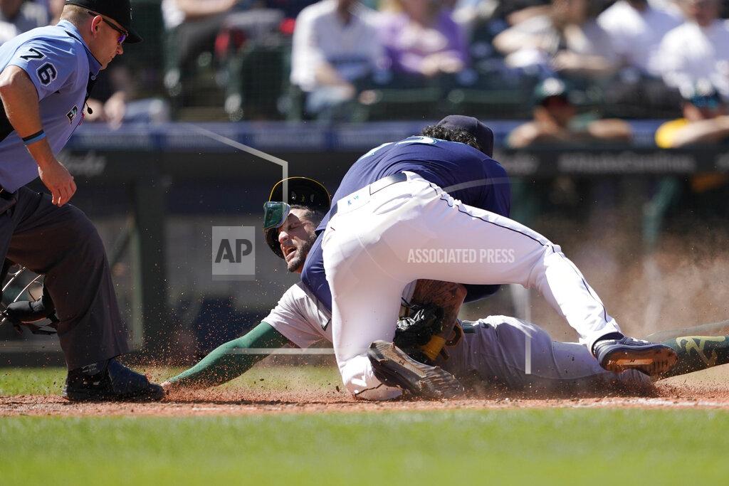 Ted S. Warren Seattle Mariners pitcher Andres Munoz tags out Oakland Athletics' Luis Barrera at the plate during the seventh inning of a baseball game Wednesday, May 25, 2022, in Seattle. (AP Photo/Ted S. Warren)