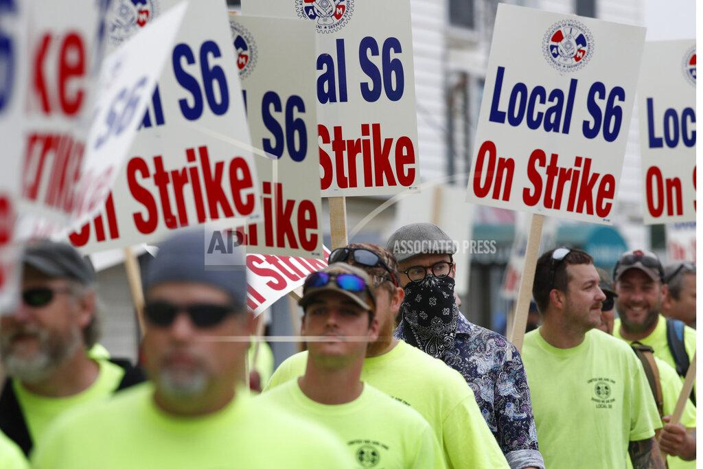 Striking shipbuilders picket outside an entrance to Bath Iron Works, Monday, June 22, 2020, in Bath, Maine. The vast majority of picketers did not wear pandemic facemarks. (AP Photo/Robert F. Bukaty)