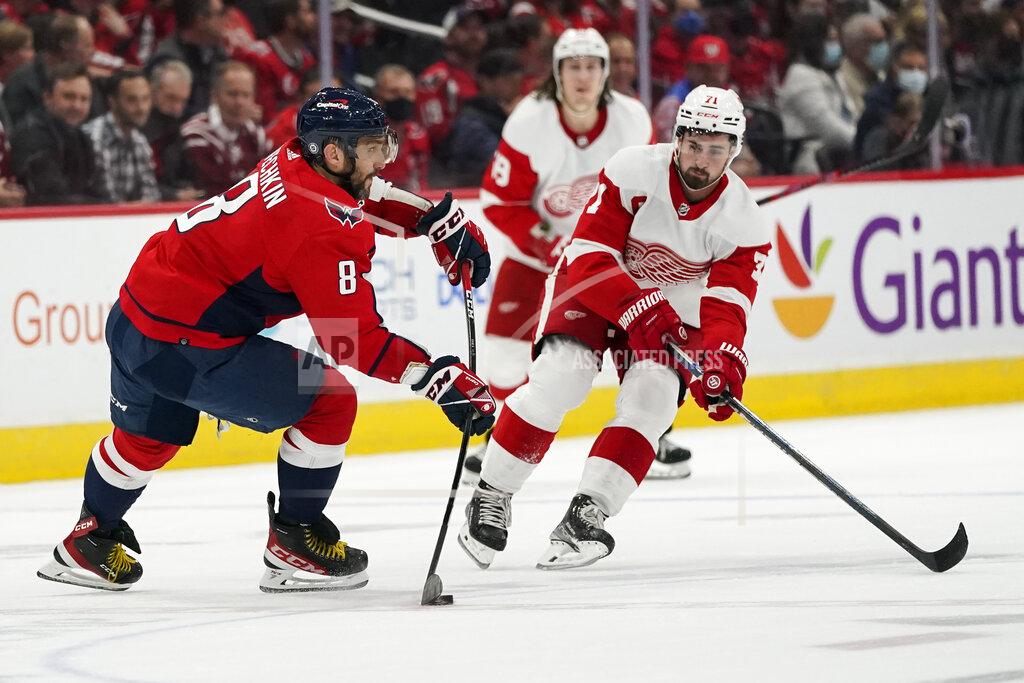 Alex Brandon Washington Capitals left wing Alex Ovechkin (8) passes the puck past Detroit Red Wings center Dylan Larkin (71) in the first period of an NHL hockey game, Wednesday, Oct. 27, 2021, in Washington. (AP Photo/Alex Brandon)