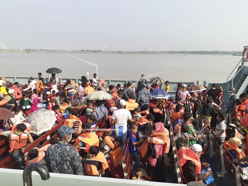 Saleh Noman Rohingya refugees board a ship as they are ferried to Bhashan Char, or floating island, in the Bay of Bengal, from Chittagong, Bangladesh, Friday, Dec. 4, 2020. Authorities in Bangladesh on Friday started sending a first group of nearly more than 1,500 Rohingya refugees to an isolated island despite calls by human rights groups for a halt to the process. (AP Photo/Saleh Noman)