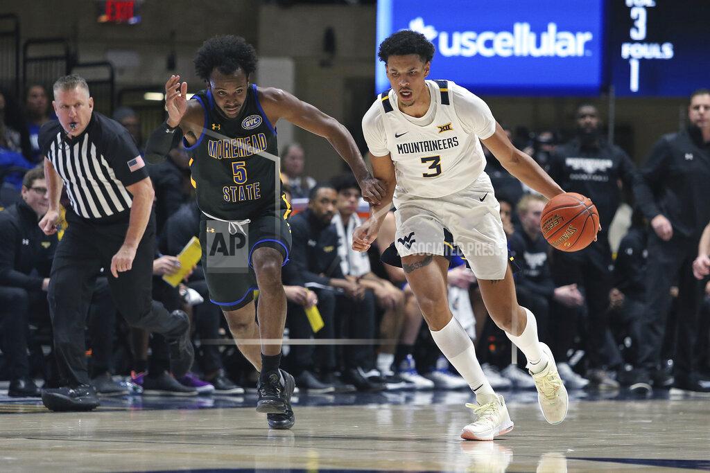Kathleen Batten West Virginia forward Tre Mitchell (3) is defended by Morehead State guard Branden Maughmer (5) during the second half of an NCAA college basketball game in Morgantown, W.Va., Tuesday, Nov. 15, 2022. (AP Photo/Kathleen Batten)