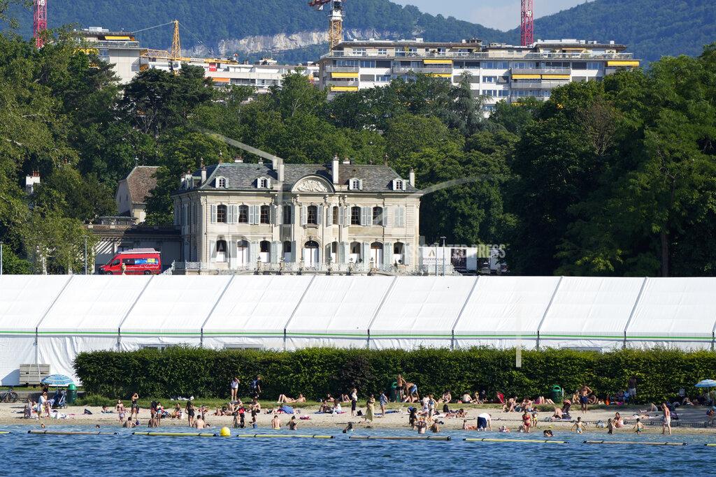 Markus Schreiber People swim on the shores of Lake Geneva in front of a tent that was set up as a media center opposite the 'Villa La Grange' the venue for the upcoming meeting between US President Joe Biden and Russian President Vladimir Putin, in Geneva, Switzerland Monday, June 14, 2021. The lakeside city known as a Cold War crossroads and a hub for Swiss discretion, neutrality and humanitarianism, is set to return to a spotlight on the world stage as U.S. President Joe Biden and Russian President Vladimir Putin come to town for a summit on Wednesday, June 16.(AP Photo/Markus Schreiber)