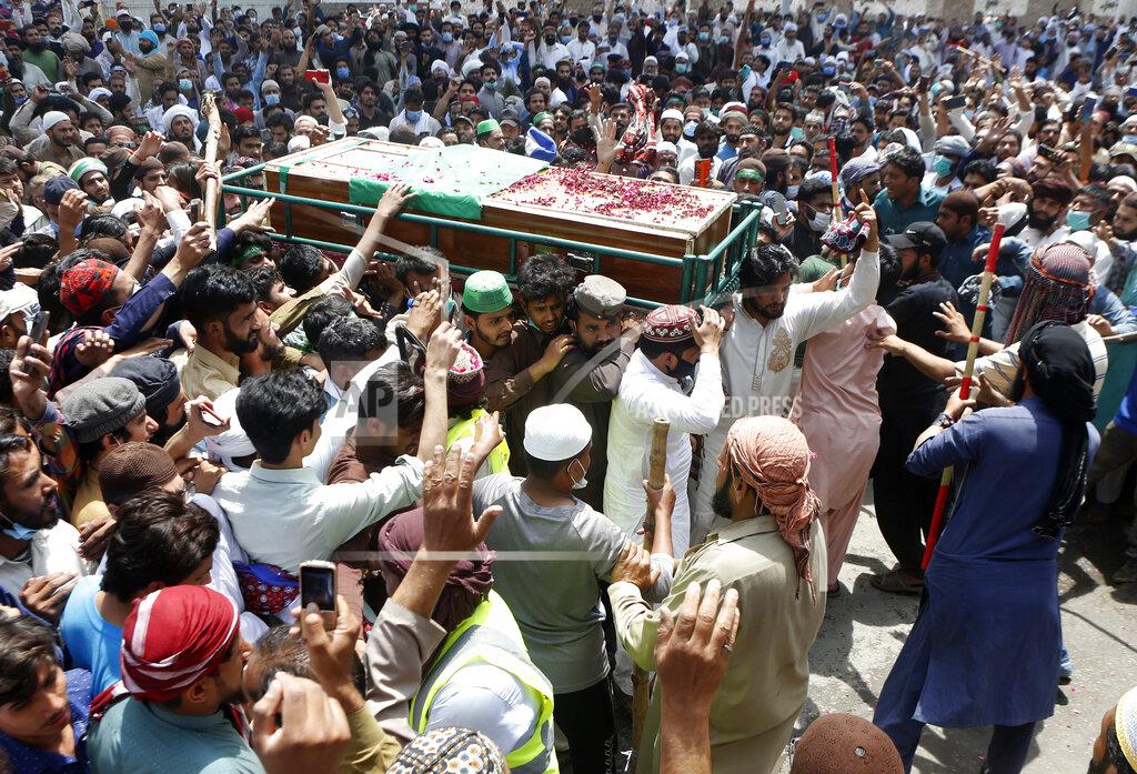 K.M. Chaudary Supporters of Tehreek-e-Labiak Pakistan, a banned Islamist party, carry a casket of their colleague, who was killed in the Sunday's clash with police, for a funeral prayer, in Lahore, Pakistan, Monday, April 19, 2021. The outlawed Pakistani Islamist political group freed 11 policemen almost a day after taking them hostage in the eastern city of Lahore amid violent clashes with security forces, the country's interior minister said Monday. (AP Photo/K.M. Chaudary)