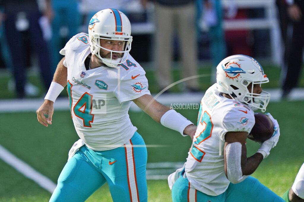 Corey Sipkin Miami Dolphins quarterback Ryan Fitzpatrick, left, hands off to Matt Breida during the first half of an NFL football game against the New York Jets, Sunday, Nov. 29, 2020, in East Rutherford, N.J. (AP Photo/Corey Sipkin)