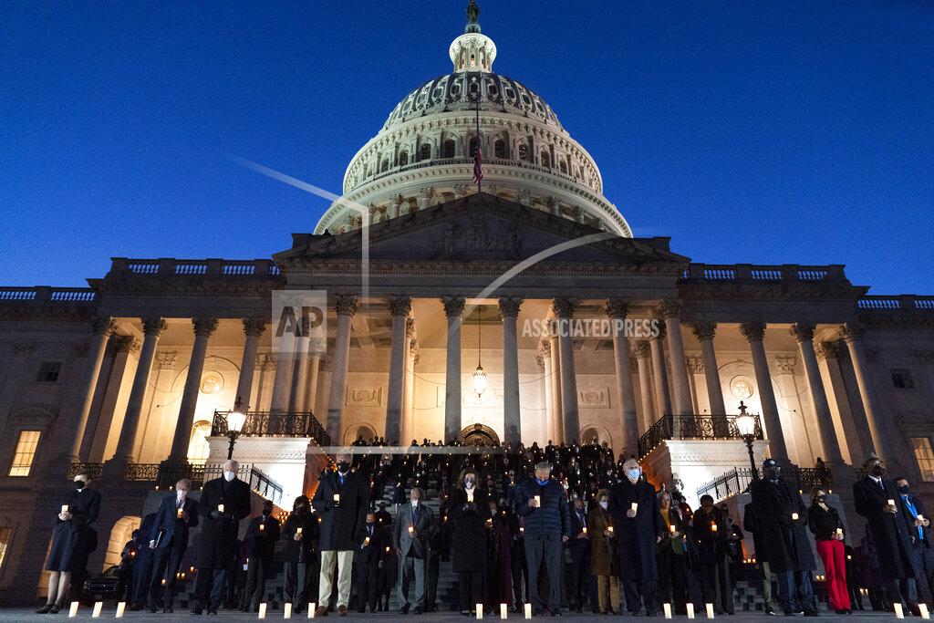 Jacquelyn Martin House Speaker Nancy Pelosi of Calif., center left, Senate Majority Leader Chuck Schumer of N.Y., center right, Senate Minority Leader Mitch McConnell of Ky., right of Schumer, and House Minority Leader Kevin McCarthy of Calif., left of Pelosi, with bipartisan members of the House and Senate, hold a moment of silence for 500,000 U.S. COVID-19 deaths, Tuesday, Feb. 23, 2021, on the east front steps of the Capitol in Washington. (AP Photo/Jacquelyn Martin)