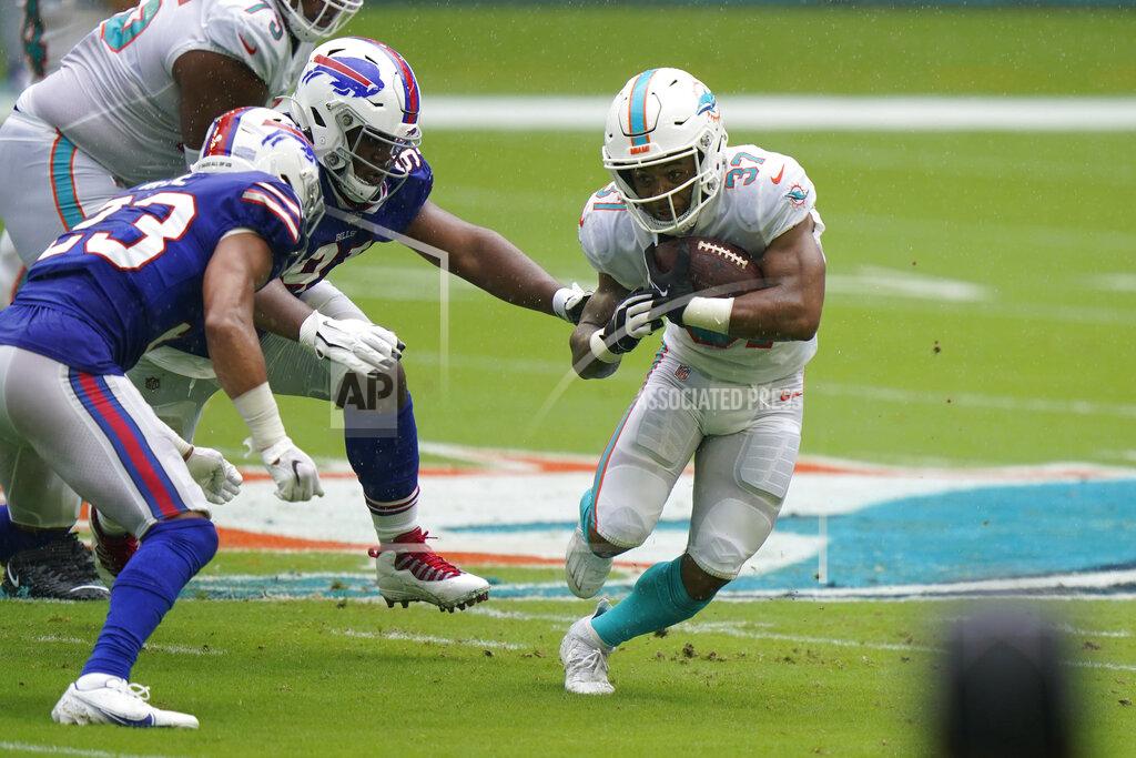 Wilfredo Lee Miami Dolphins running back Myles Gaskin (37) runs the ball A Buffalo Bills strong safety Micah Hyde (23) attempts to stop him, during the first half of an NFL football game, Sunday, Sept. 20, 2020 in Miami Gardens, Fla. (AP Photo/Wilfredo Lee)
