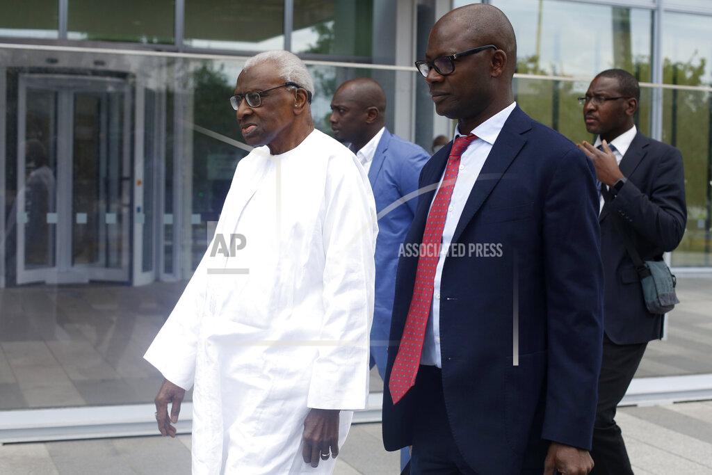 Thibault Camus Former president of the IAAF (International Association of Athletics Federations) Lamine Diack, left, arrives at the Paris courthouse, Wednesday, June 10, 2020. A sweeping sports corruption trial opened Monday in Paris involving allegations of a massive doping cover-up that reached to the top of world track and field's governing body. Lamine Diack, 87, who served as president of the body for nearly 16 years, is among those accused of receiving money from Russian athletes to hide their suspected doping so they could compete at the Olympics in 2012 and other competitions. (AP Photo/Thibault Camus)