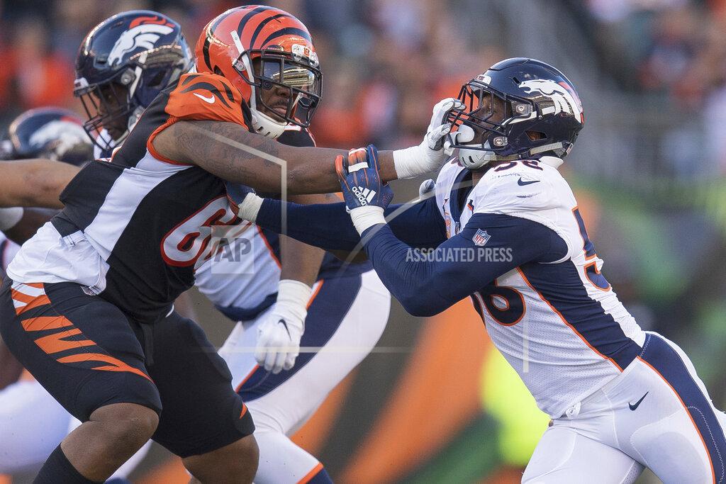 Bryan Woolston FILE - In this Dec. 2, 2018, file photo, Cincinnati Bengals offensive tackle Bobby Hart (68) grabs the face mask of Denver Broncos outside linebacker Von Miller (58) during the second half of the NFL football game played in Cincinnati. The Bengals are keeping right Hart with a three-year deal. The Bengals signed Hart as a free agent from the Giants last year as a stopgap measure, trying to improve their horrid line. Hart started all 16 games, but the right side of the line struggled as Cincinnati finished with a third straight losing season. (AP Photo/Bryan Woolston, File)
