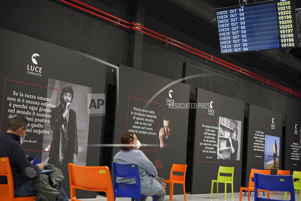 Andrew Medichini People sit in a waiting room after receiving a dose of the Pfizer COVID-19 vaccine, at a vaccination center set at Rome's Cinecitta' film studios, Tuesday, April 20, 2021. (AP Photo/Andrew Medichini)