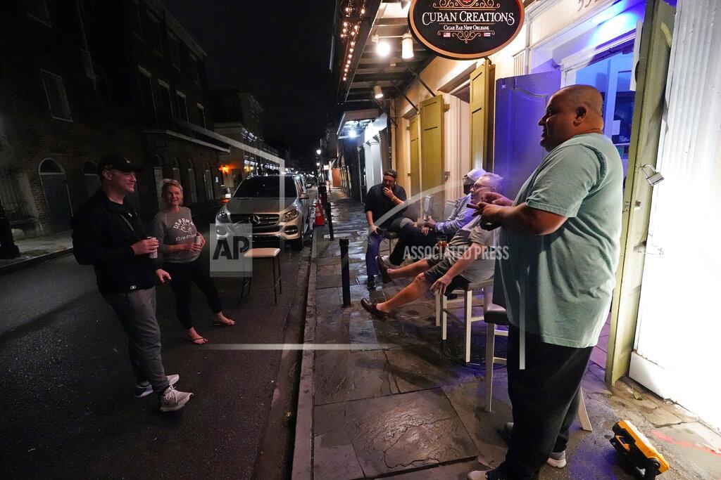 Gerald Herbert Patrons resume their socializing at Cuban Cigar Bar in the French Quarter in New Orleans, after power was restored Wednesday, Oct. 28, 2020. Hurricane Zeta passed through today leaving much of the city and metro area without power. (AP Photo/Gerald Herbert)