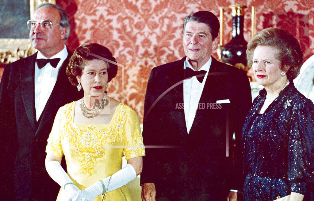 Uncredited FILE - The June 10, 1984 file photo shows Queen Elizabeth II, second left, standing with, West German Chancellor Helmut Kohl, left, U.S. President Ronald Reagan, second right, and Britain's Prime Minister Margaret Thatcher at London's Buckingham Palace, prior to a dinner for summit leaders. (AP Photo, File)