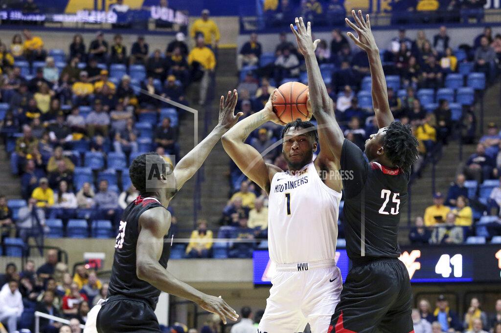 Kathleen Batten West Virginia forward Derek Culver (1) is defended by Nicholls State forward Elvis Harvey Jr. (23) and forward Warith Alatishe (25) as he goes to pass the ball during the second half of an NCAA college basketball game Saturday, Dec. 14, 2019, in Morgantown, W.Va. Culver had 16 points against Nicholls State. (AP Photo/Kathleen Batten)