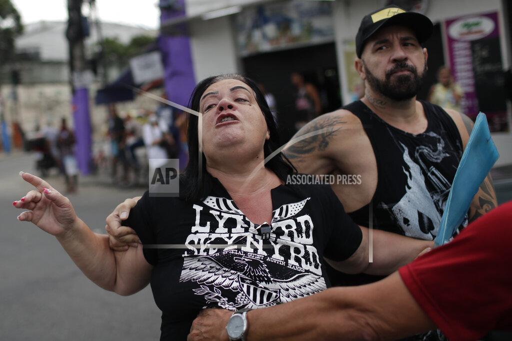 Silvia Izquierdo The relative of a victim shouts against the police during a protest one day after a deadly police operation in the Jacarezinho favela in Rio de Janeiro, Brazil, Friday, May 7, 2021. A bloody, hours-long gunbattle here echoed into Friday, with authorities saying the police mission killed two dozen criminals while residents and activists claimed human rights abuses. (AP Photo/Silvia Izquierdo)