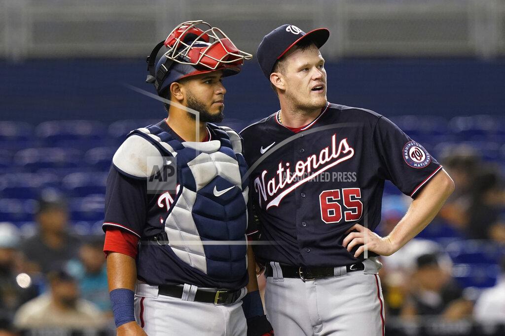 Marta Lavandier Washington Nationals' catcher Keibert Ruiz and pitcher Josh Rogers (65) watch the replay of a hit by Miami Marlins' Miguel Rojas during the third inning of a baseball game against the Miami Marlins, Tuesday, Sept. 21, 2021, in Miami. (AP Photo/Marta Lavandier)