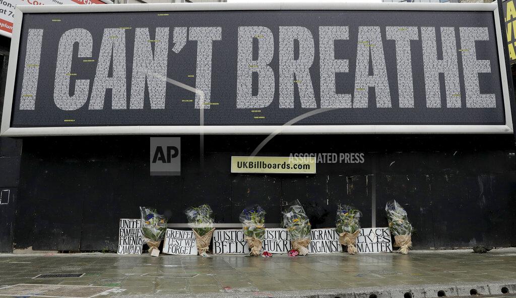 Matt Dunham A billboard with a memorial of flowers which was unveiled by UK's Black Lives Matter ahead of expected rival demonstrations by anti-racism and far-right protesters in London, Friday, June 12, 2020 in response to the recent killing of George Floyd by police officers in Minneapolis, USA, that has led to protests in many countries and across the US.(AP Photo/Matt Dunham)