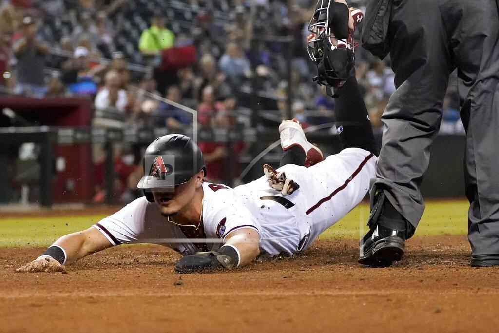 Matt York Arizona Diamondbacks' Josh Rojas scores on a double by Ketel Marte against Atlanta Braves during the third inning of a baseball game, Monday, Sept. 20, 2021, in Phoenix. (AP Photo/Matt York)