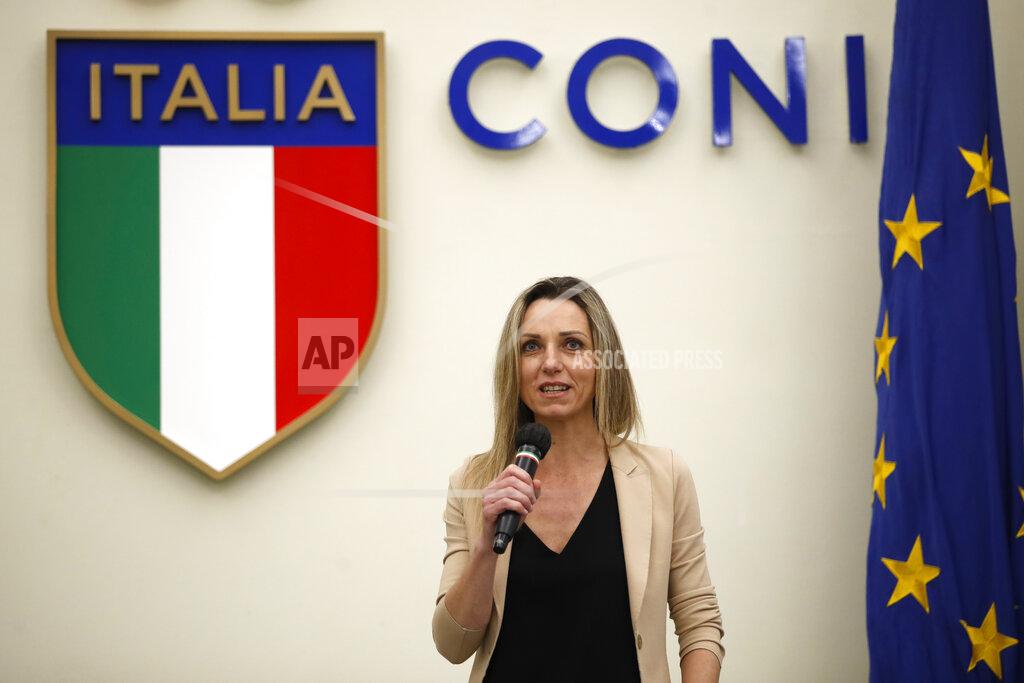 Alessandra Tarantino Cabinet undersecretary and Olympic champion Valentina Vezzali speaks at a press conference to unveil the logo of 2026 Milan-Cortina Olympics and Paralympics, in Rome, Tuesday, March 30, 2021. In an online vote, nearly a million votes were cast -- 871,566 to be exact -- over the last two weeks from Italy and 168 other nations for the two finalists. The “Futura” logo received 75 percent of the votes, winning easily ahead of the more traditional “Dado” option. (AP Photo/Alessandra Tarantino)