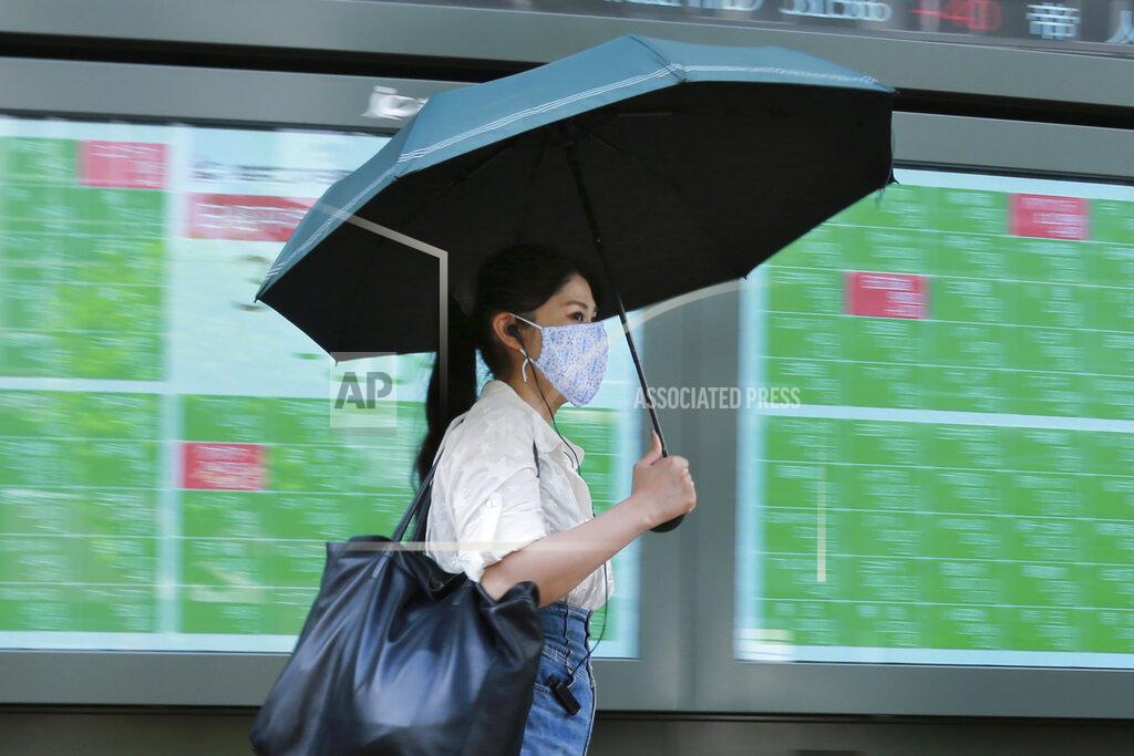 Koji Sasahara A woman walks by an electronic stock board of a securities firm in Tokyo, Wednesday, Sept. 15, 2021. Asian stock markets followed Wall Street down on Wednesday after U.S. inflation was lower than expected amid unease about the impact of the spread of the coronavirus's delta variant. (AP Photo/Koji Sasahara)