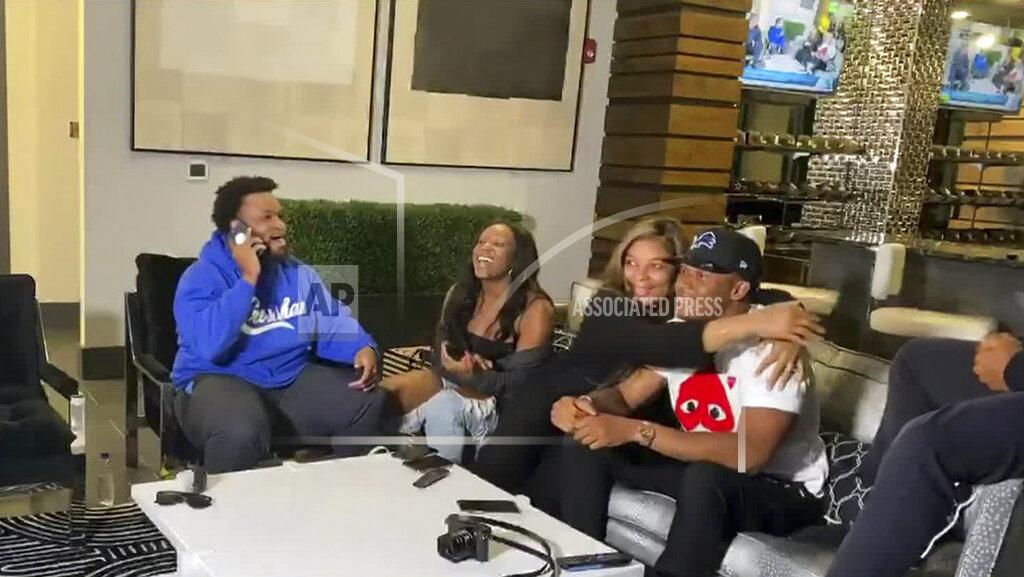 Uncredited In this still image from video provided by the NFL, Julian Okwara, wearing cap, is hugged after being selected by the Detroit Lions during the third round of the NFL football draft, Friday, April 24, 2020. (NFL via AP)