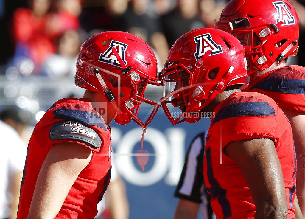 Rick Scuteri Arizona wide receiver Tony Ellison, left, celebrates with Khalil Tate (14) after scoring a touchdown against Arizona State in the first half during an NCAA college football game, Saturday, Nov. 24, 2018, in Tucson, Ariz. (AP Photo/Rick Scuteri)