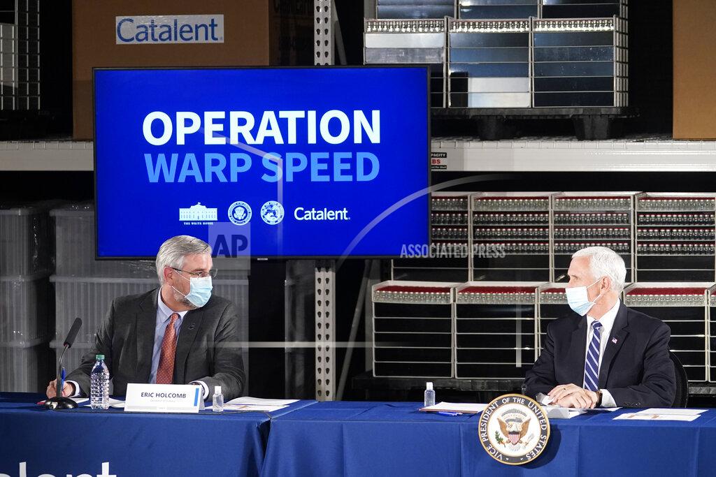 Darron Cummings Vice President Mike Pence listens as Indiana Gov. Eric Holcomb speaks during a round table discussion at Catalent Biologics, Tuesday, Dec. 15, 2020, in Bloomington, Ind. (AP Photo/Darron Cummings)
