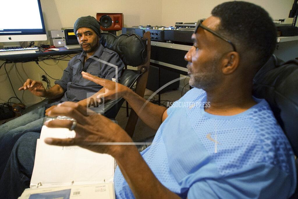 Allen G. Breed Musician Youtha Anthony Fowler, known as DJ Nabs, left, listens to lifelong best friend Alton Lucas talk about his drug addiction in Nabs' home studio outside of Raleigh, N.C., on Saturday, June 26, 2021. By their teenage years, Lucas and Fowler were deejaying for college parties at nearby Duke University. Together, “Luke Duke,” as Lucas was known, and “Nabisco Disco,” as Fowler was called, helped popularize hip-hop music among undergraduates. (AP Photo/Allen G. Breed)