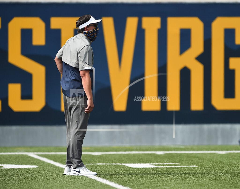 William Wotring/ The Dominion Post West Virginia head coach Neal Brown makes his way onto the field during warmups before an NCAA college football game against Eastern Kentucky on Saturday, Sept. 12, 2020, in Morgantown, W.Va. (William Wotring/The Dominion-Post via AP)