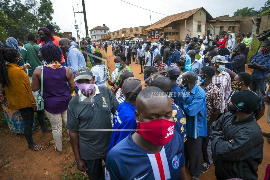 Jerome Delay Ugandans wait to vote in Kampala, Uganda, Thursday, Jan. 14, 2021. Ugandans are voting in a presidential election tainted by widespread violence that some fear could escalate as security forces try to stop supporters of leading opposition challenger BobiWine from monitoring polling stations.(AP Photo/Jerome Delay)