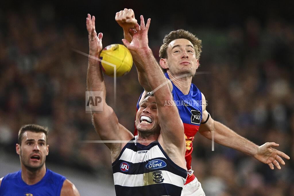 Joel Carrett Harris Andrews of the Lions and Tom Hawkins of Geelong during the AFL Preliminary Final match between the Geelong Cats and the Brisbane Lions at the Melbourne Cricket Ground in Melbourne, Friday, Sept. 16, 2022. Early Saturday morning, at a half past midnight, a small but passionate group of fans will gather in front of their TVs in America. They'll be watching the Grand Final, the Super Bowl of Aussie rules football. (AAP Image/Joel Carrett)