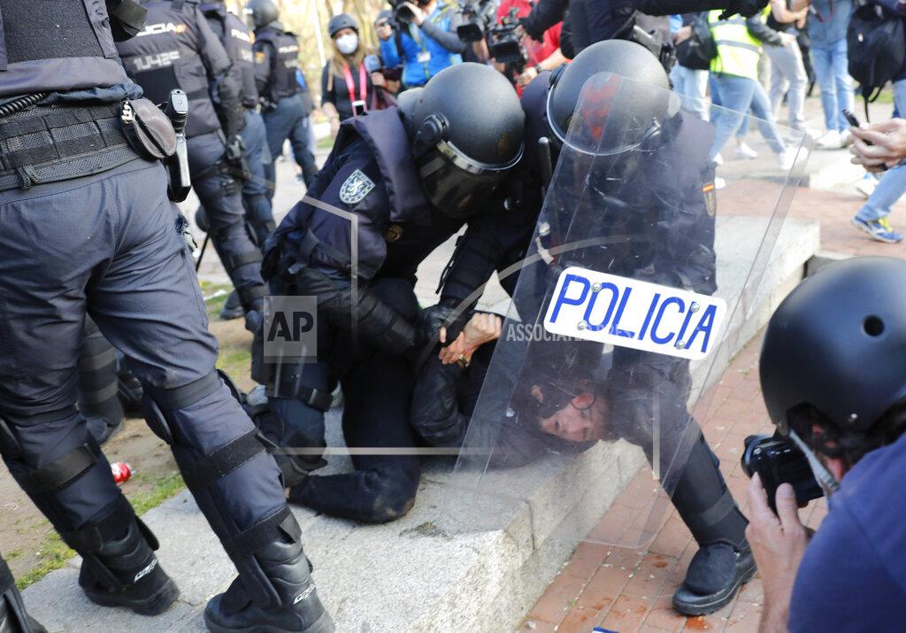 Bernat Armangue A protester is detained by Spanish police as they try to keep them away from supporters of the far-right Vox party during a party rally in Madrid's Vallecas neigborhood, a traditional left-wing bastion, Spain, Wednesday, April 7, 2021. Scuffles started when the national leader of Vox, Santiago Abascal, approached a crowd which had gathered to protest the party rally. Riot peace charged the bunches of protesters to keep them away from Abascal and other members of his party campaigning for upcoming regional elections in the area including Spain's capital. (AP Photo/Bernat Armangue)