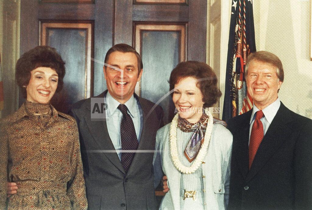 Peter Bregg FILE - In this Jan. 21, 1977, file photo, President Jimmy Carter, right, and Rosalynn Carter, second from right, pose with Vice President Walter Mondale and wife, Joan Mondale, left, following Carter's inauguration in the White House Blue Room in Washington. Mondale, a liberal icon who lost the most lopsided presidential election after bluntly telling voters to expect a tax increase if he won, died Monday, April 19, 2021. He was 93. (AP Photo/Peter Bregg, File)