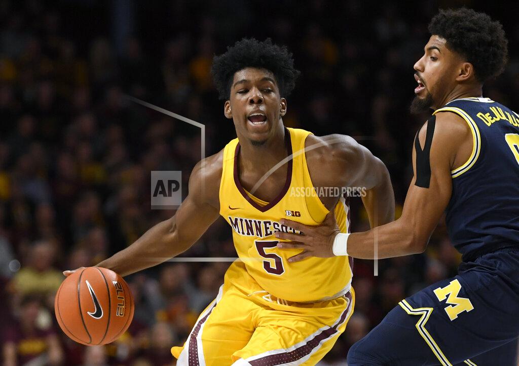 Hannah Foslien Michigan's David DeJulius, right, guards against Minnesota's Marcus Carr (5) in the first half during an NCAA college basketball game on Sunday, Jan. 12, 2020, in Minneapolis. (AP Photo/Hannah Foslien)