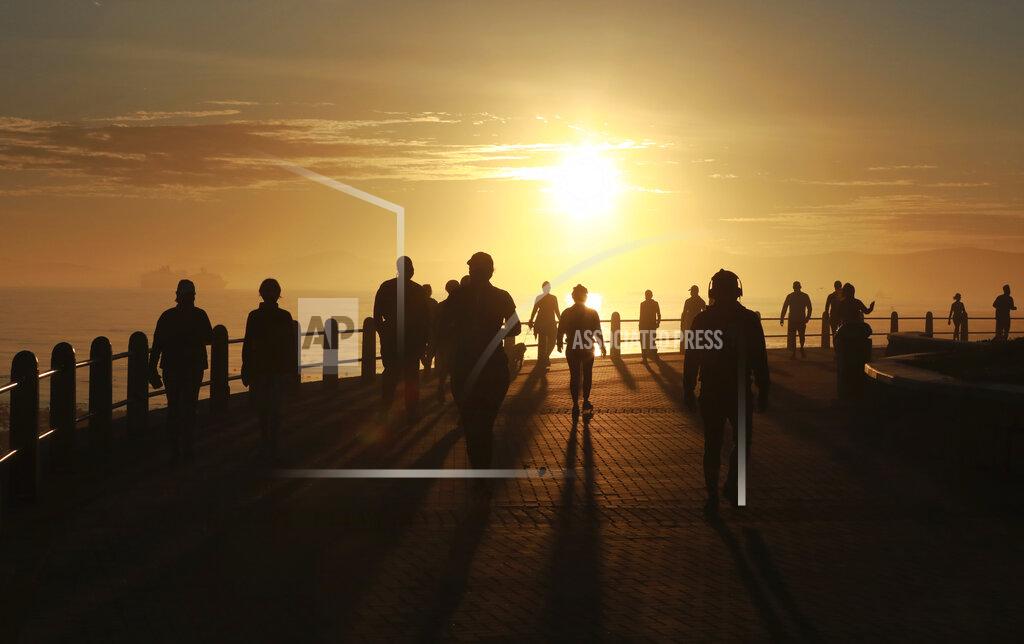Nardus Engelbrecht FILE- In this file photo taken Monday May 18, 2020, people exercise along the promenade at sunrise in Sea Point, Cape Town, South Africa, as the country marked day 53 of a strict government lockdown in a bid to prevent the spread of coronavirus. South Africa is struggling to balance its fight against the coronavirus with its dire need to resume economic activity. The country with the Africa’s most developed economy also has its highest number of infections — more than 19,000. (AP Photo/Nardus Engelbrecht, file)