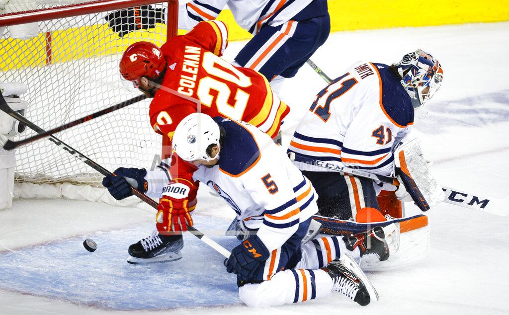 Jeff Mcintosh Edmonton Oilers' Cody Ceci (5) checks Calgary Flames forward Blake Coleman, left, who scores an apparent goal that was called off after review, while goalie Mike Smith loses track of the puck during the third period of Game 5 of an NHL hockey second-round playoff series Thursday, May 26, 2022, in Calgary, Alberta. (Jeff McIntosh/The Canadian Press via AP)